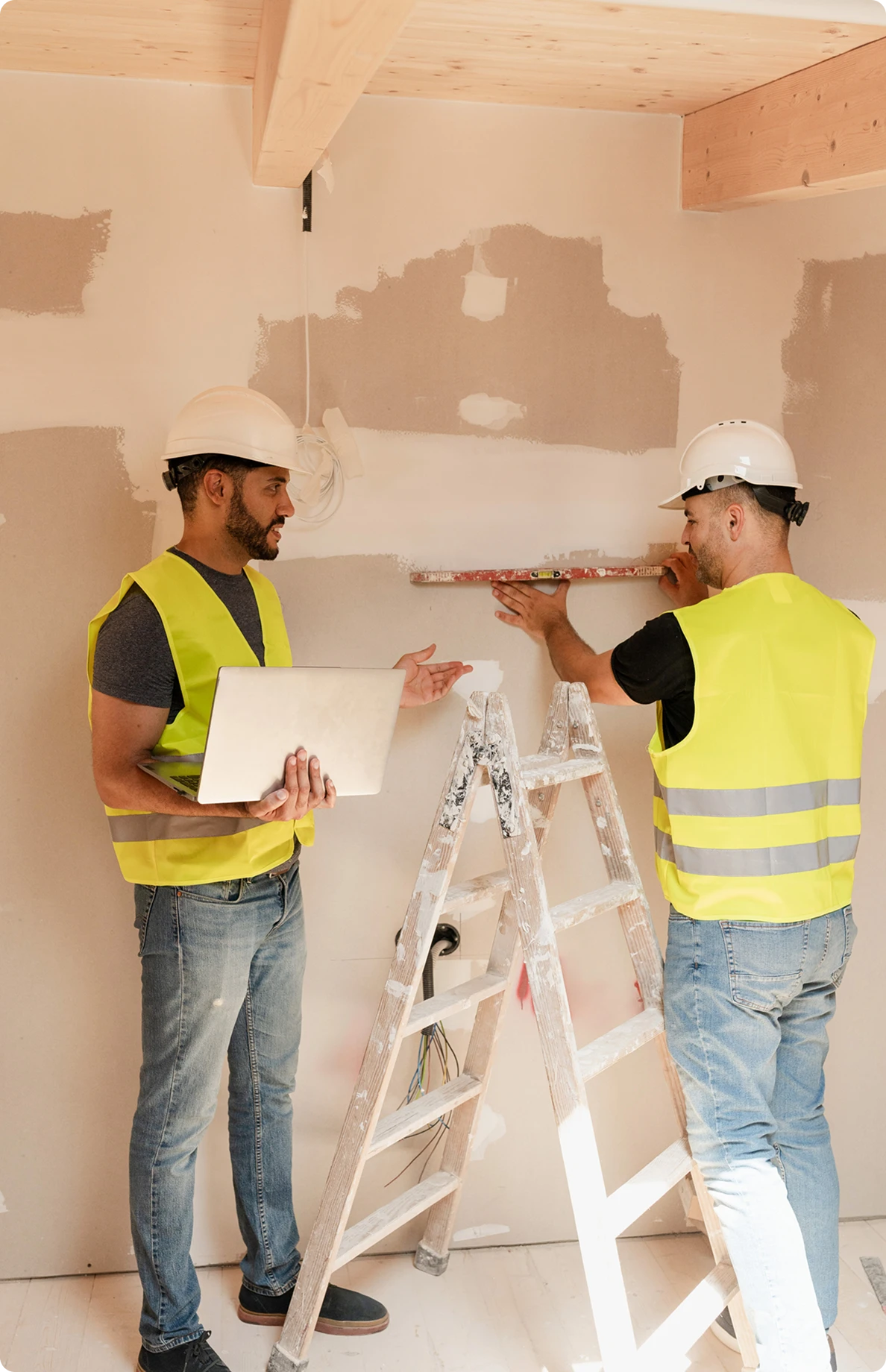 Builders in safety gear at construction site