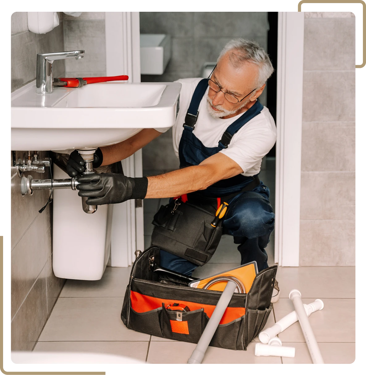 Handyman repairing under-sink plumbing