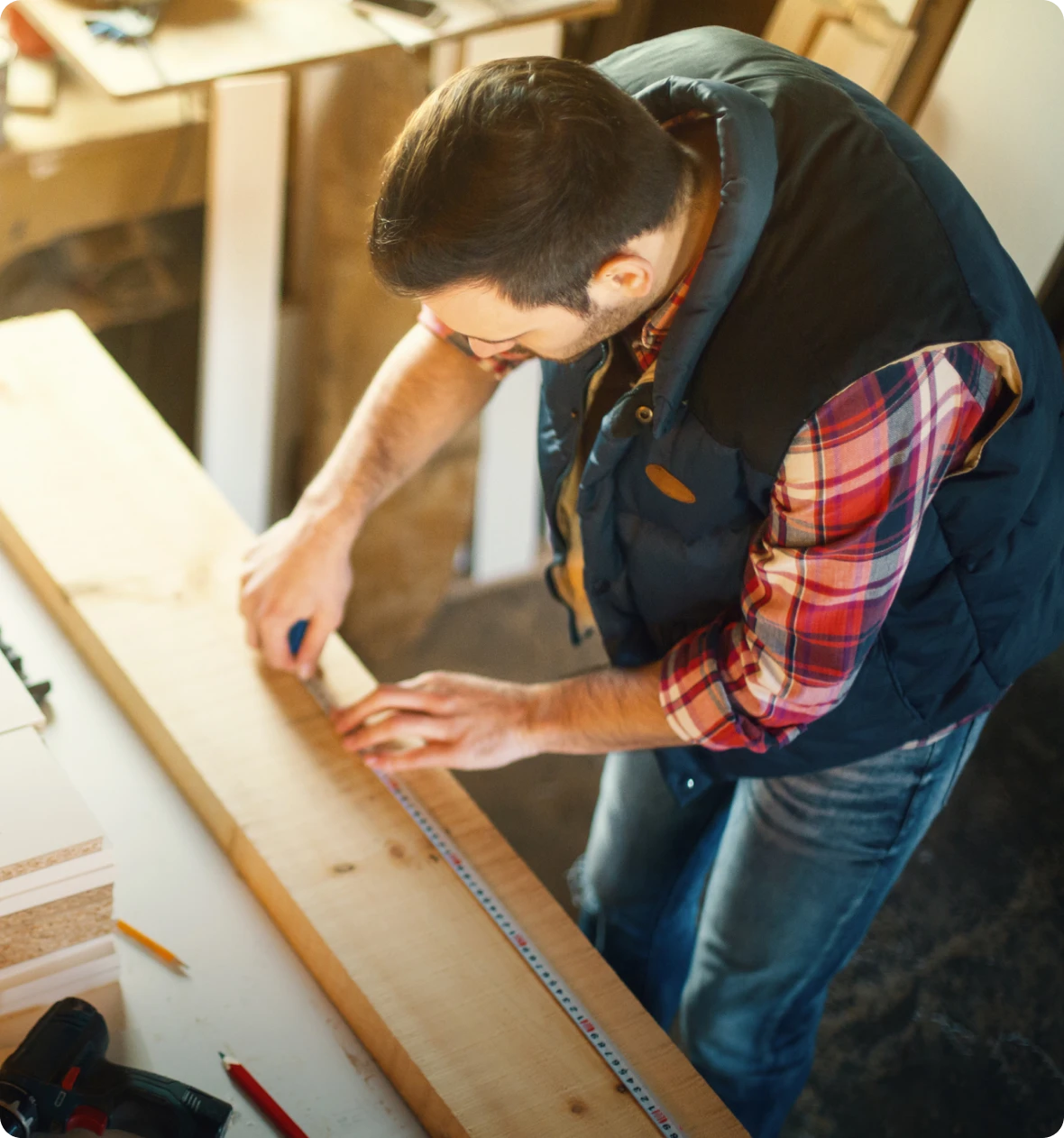 Man measuring wood with tape measure