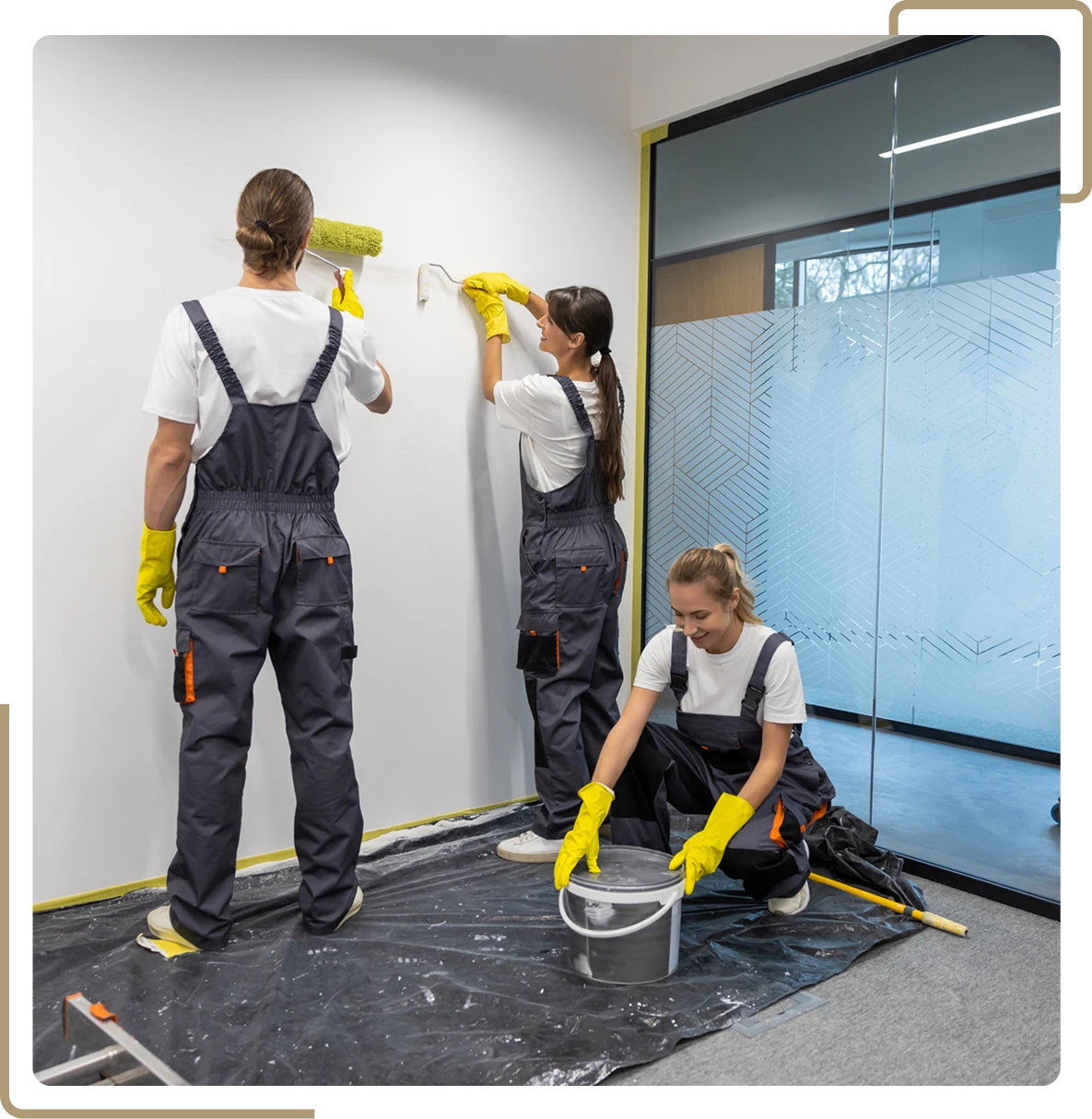 Workers in overalls painting room walls