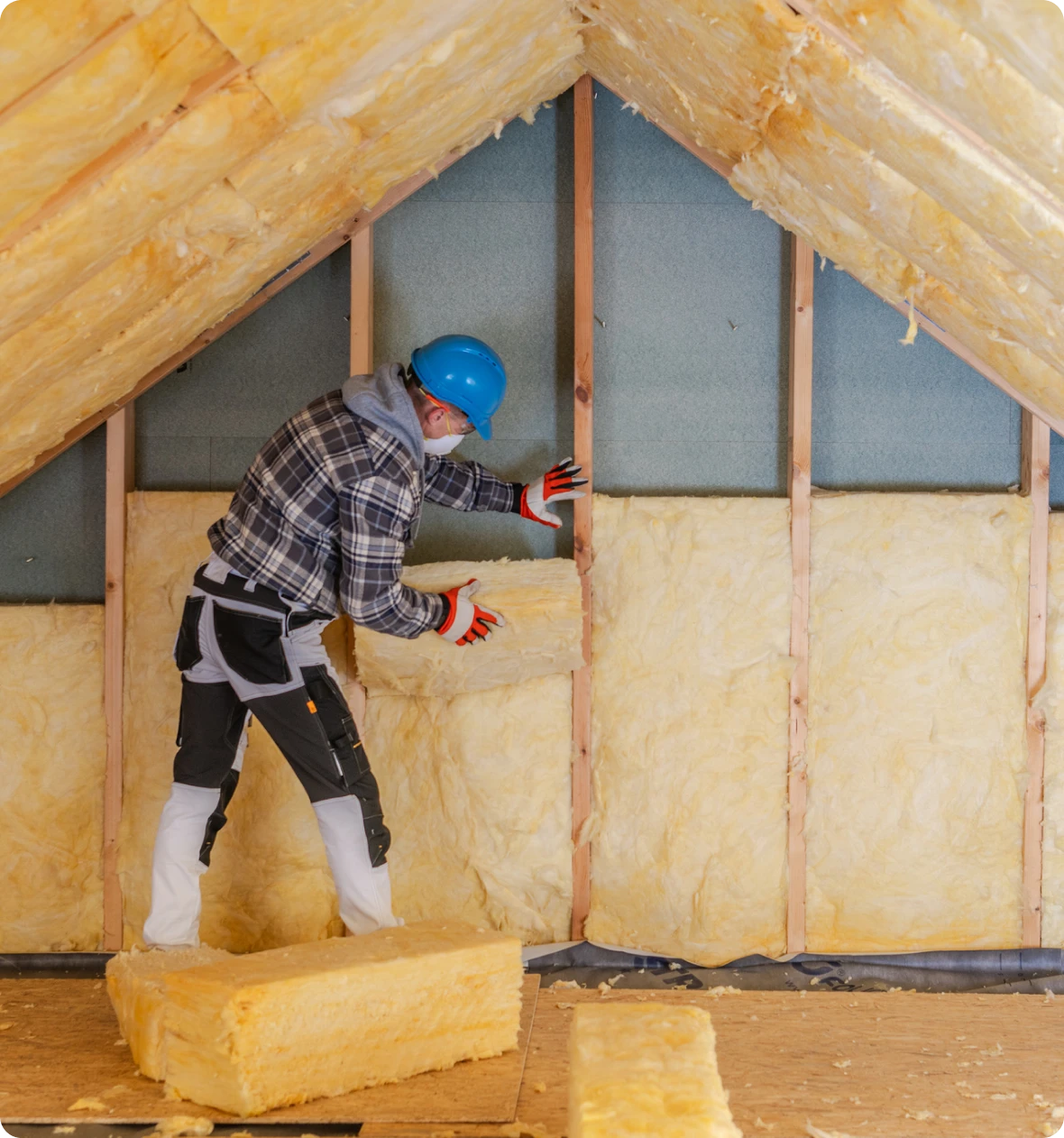 Man insulating attic with fiberglass