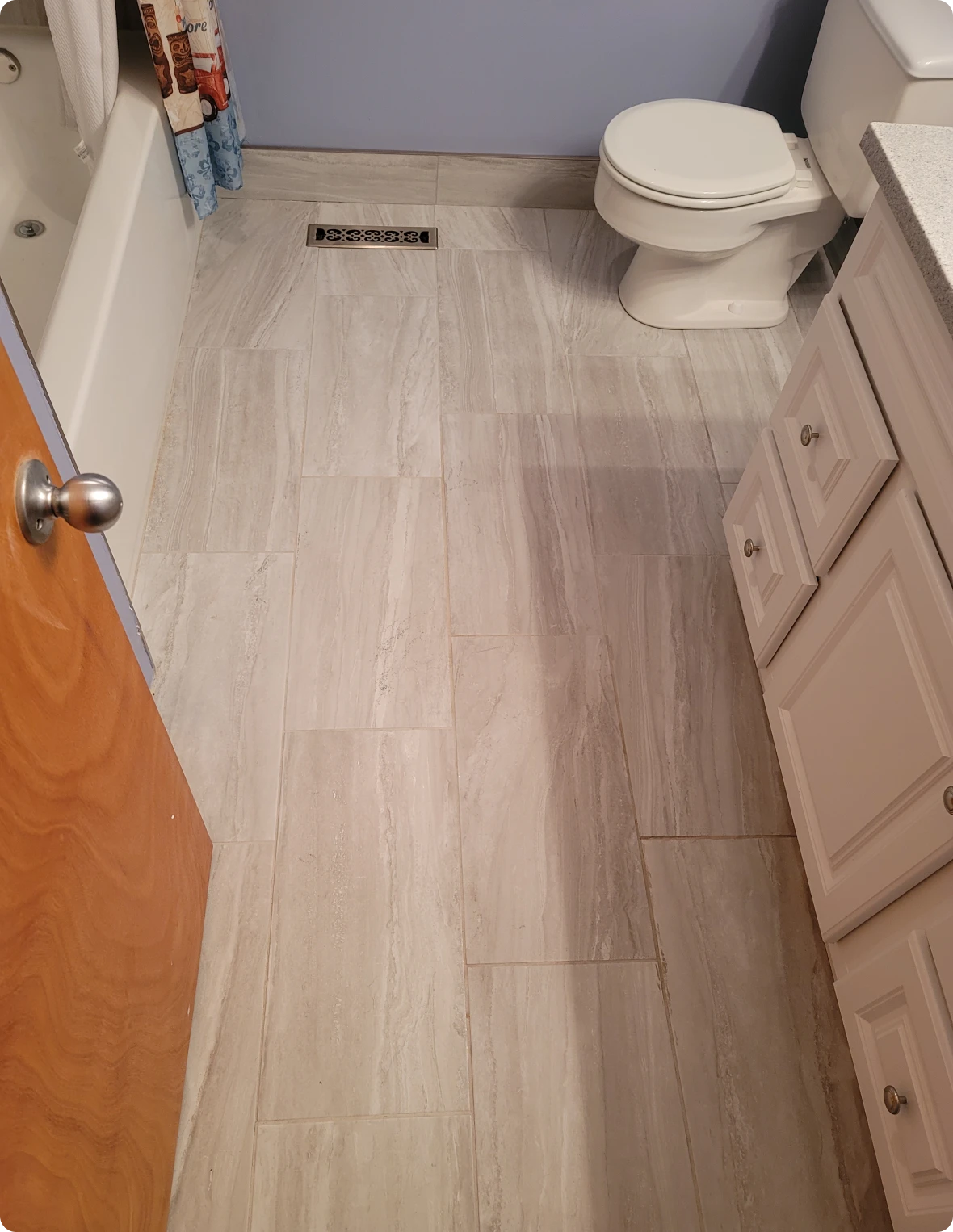 Bathroom with tiled floor and white fixtures